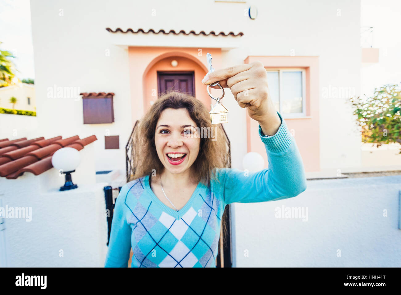 Woman With Keys Standing Outside New Home Stock Photo - Alamy