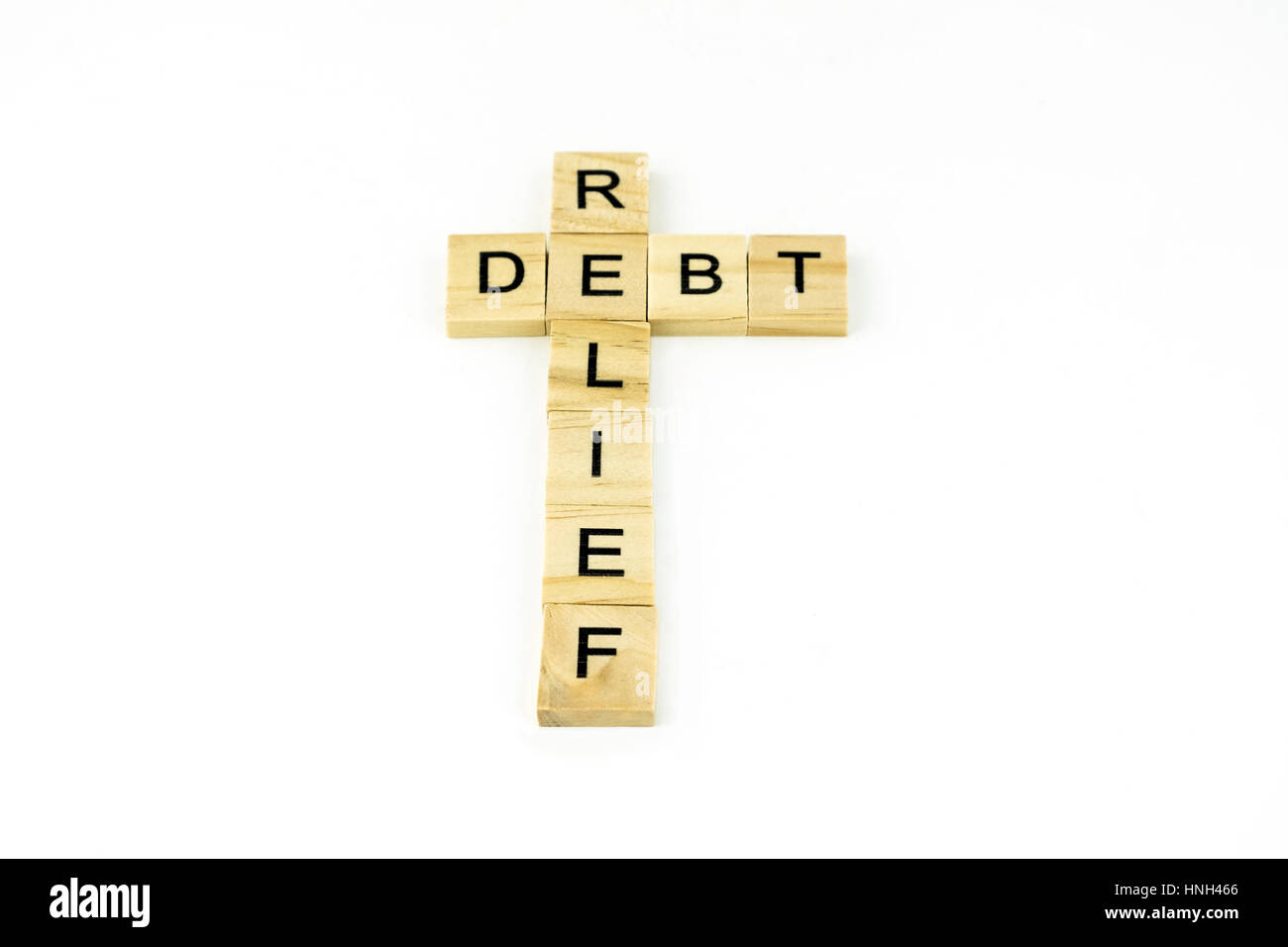 Concept debt reflief spelled out in wood blocks. Stock Photo