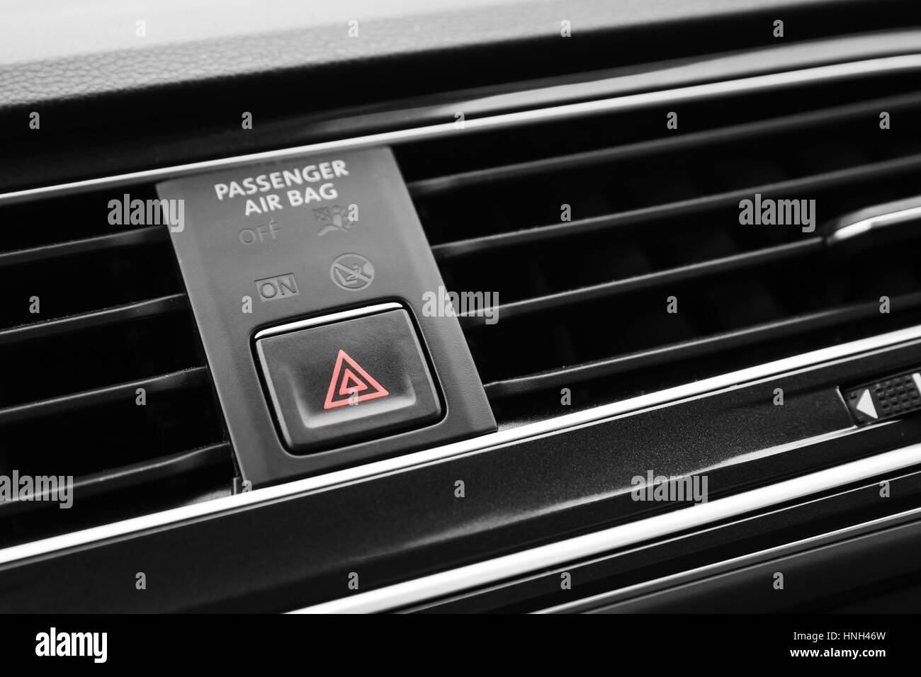 Emergency stop button with red tiangle sign, modern black car interior details Stock Photo
