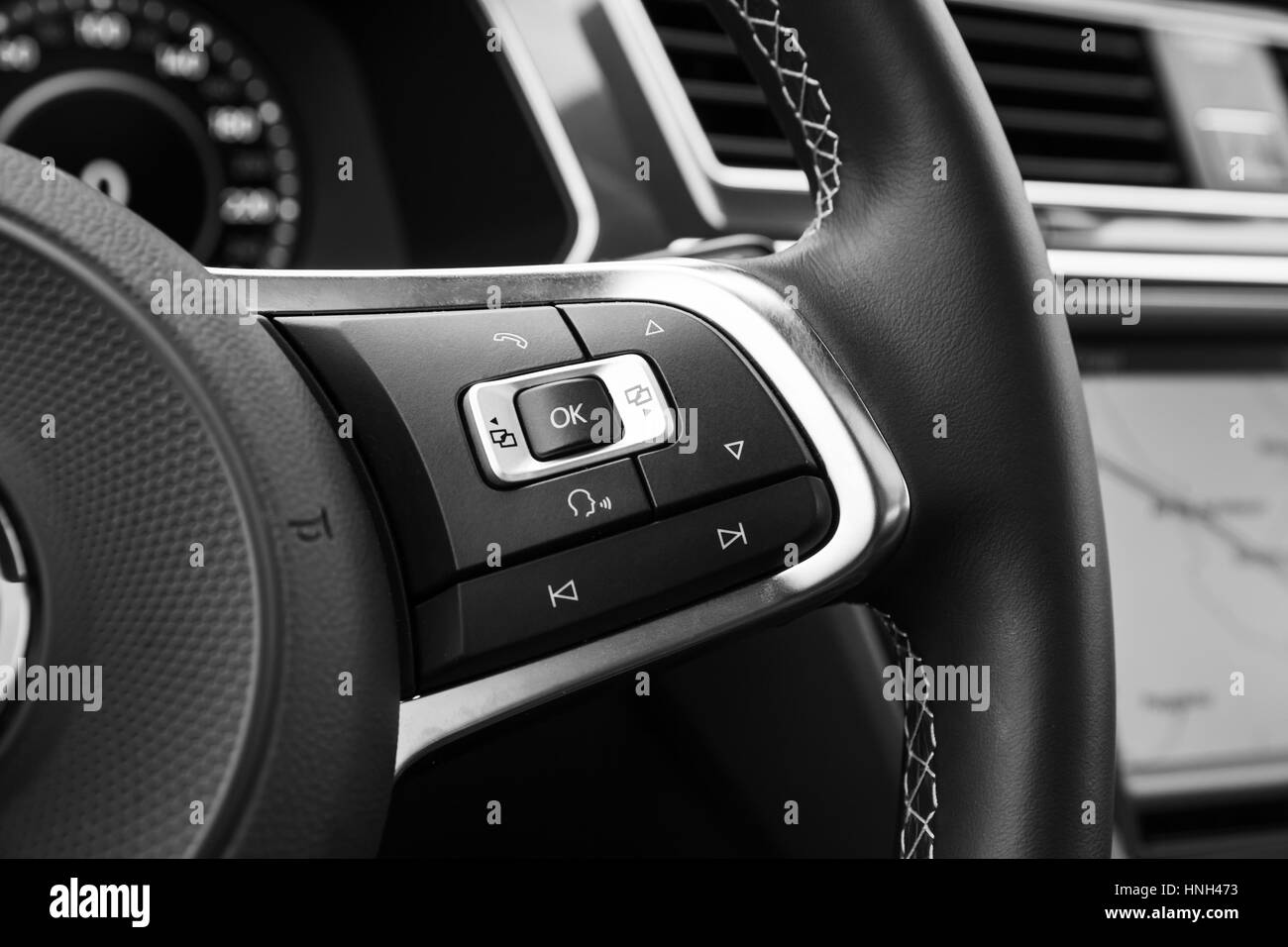 Control panel buttons on modern car steering wheel, interior details Stock Photo