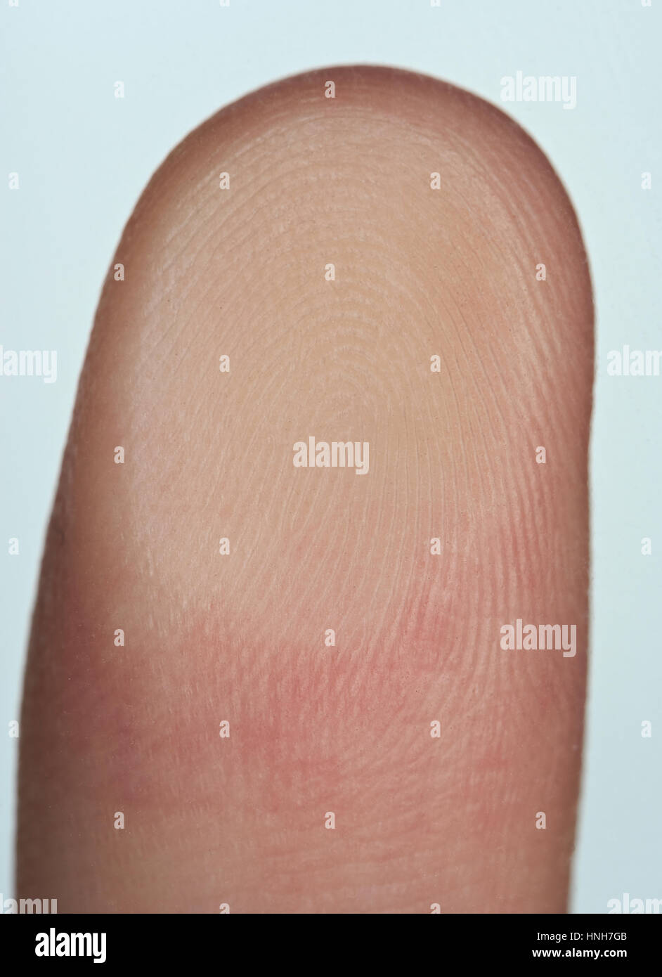 Closeup of finger print close to glass isolated on white Stock Photo