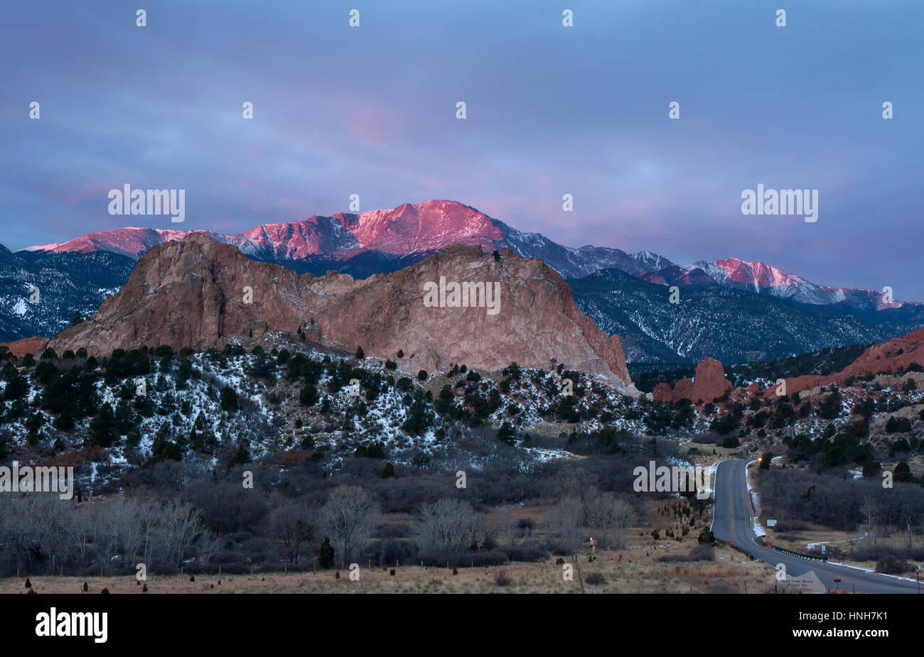 Pikes Peak Mountain glows in the sunrise at Garden of the Gods in Colorado Springs, Colorado Stock Photo