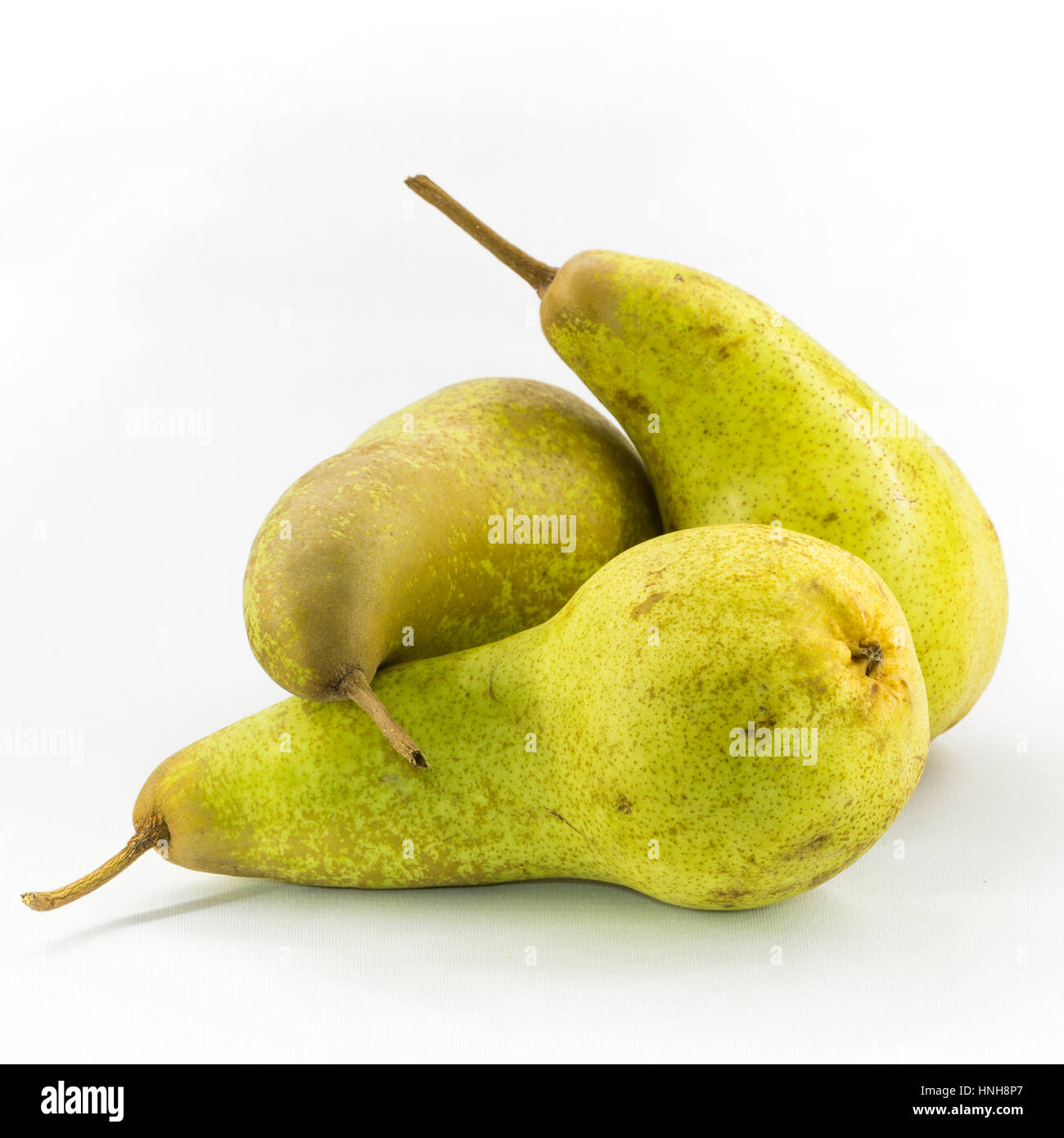 Three Abate Fetel pears isolated on white background. Stock Photo