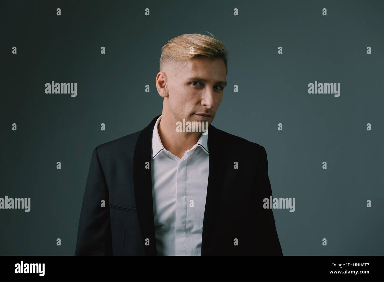 Handsome blond young man posing at studio Stock Photo - Alamy