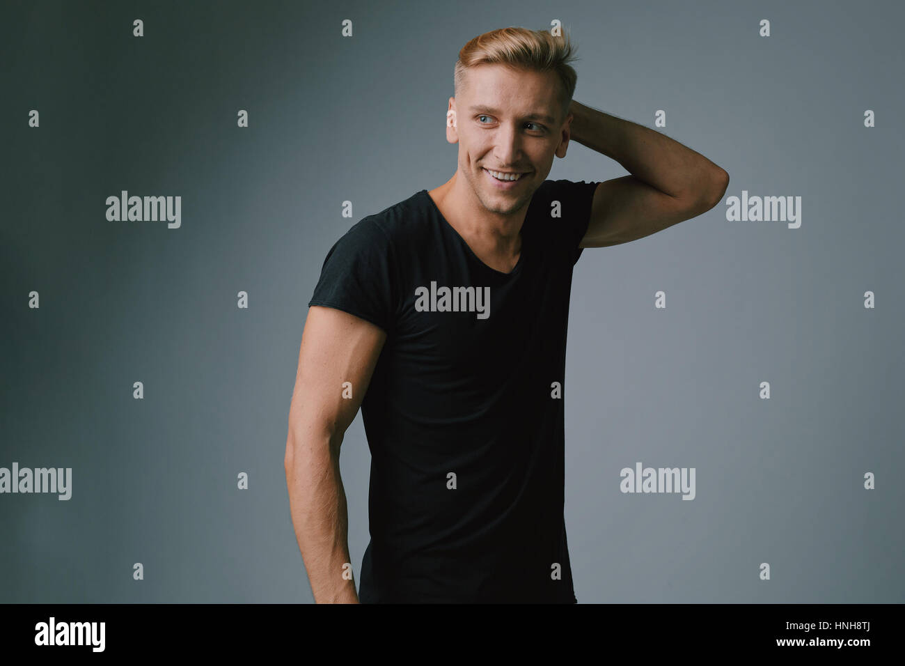 Handsome blond young man posing at studio Stock Photo - Alamy