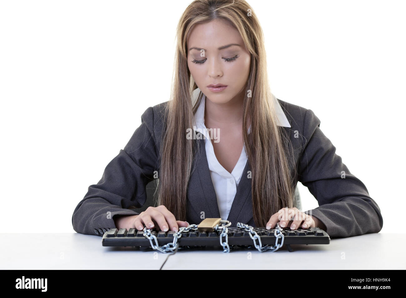 female business woman sitting at her desk locked out of computer Stock Photo