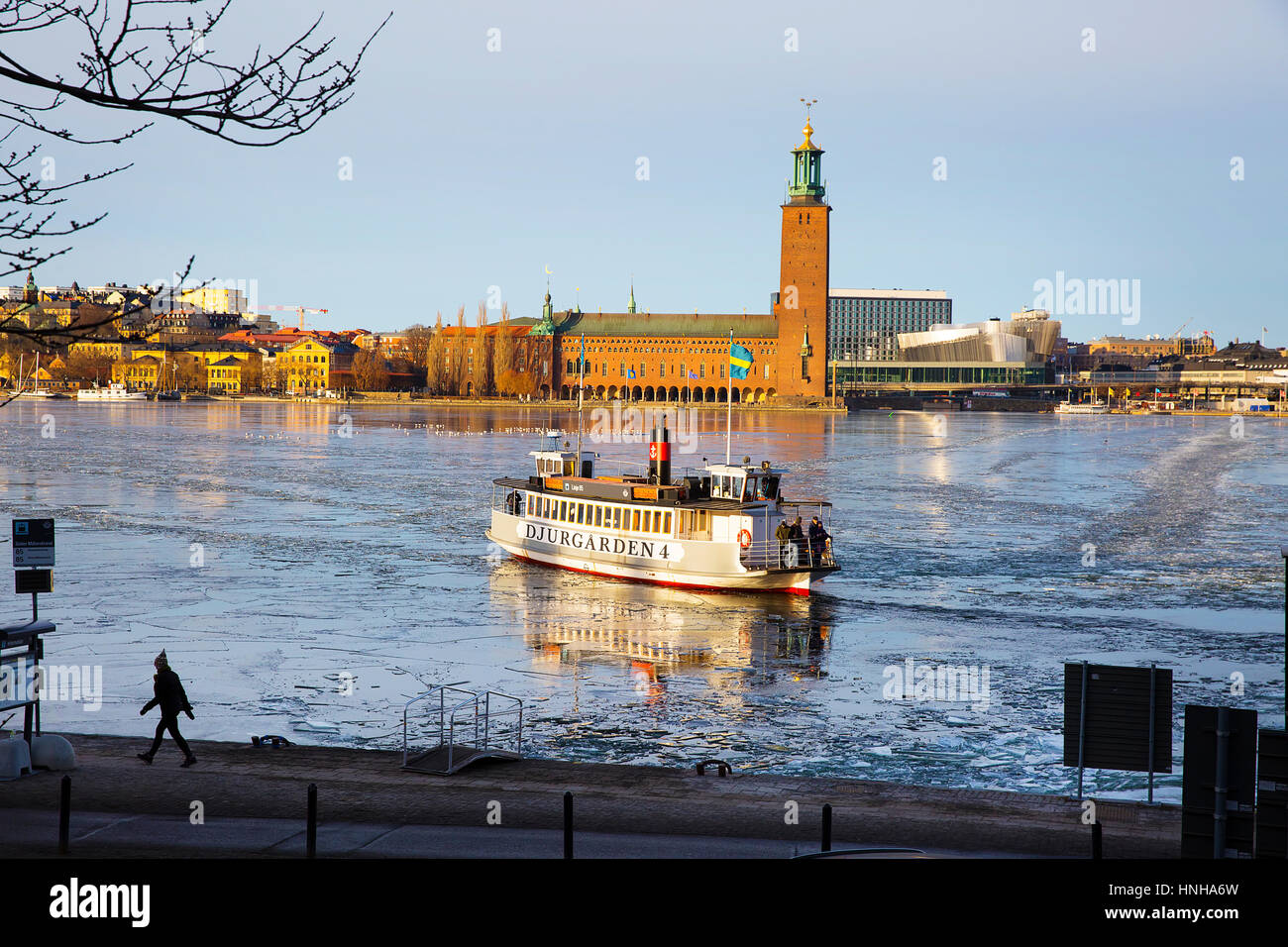 Stockholm, Sweden - February 12, 2017. Ferry crosses Riddarfjarden, to stop by City Hall. Stock Photo