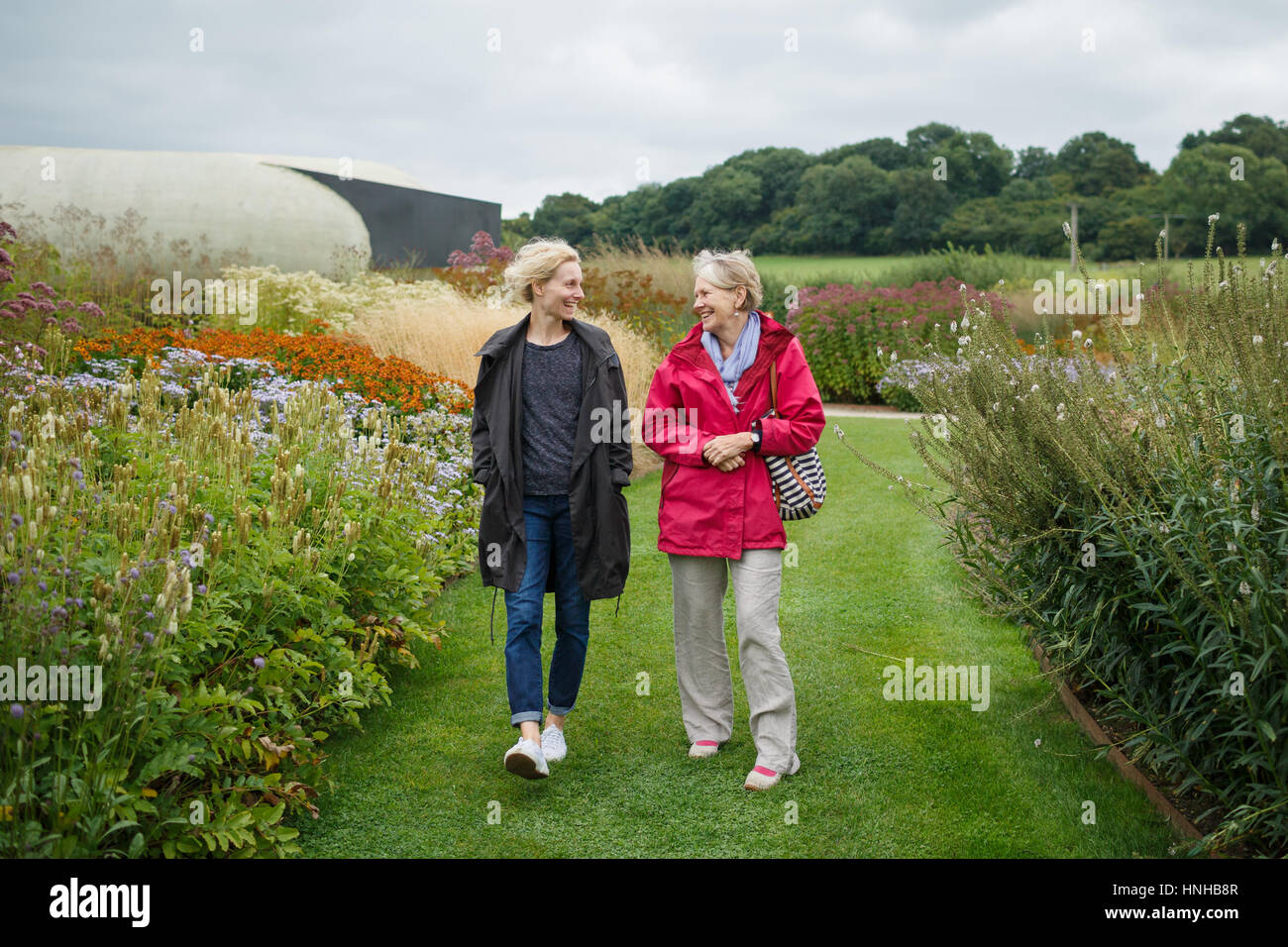 2 women walking around a garden Stock Photo