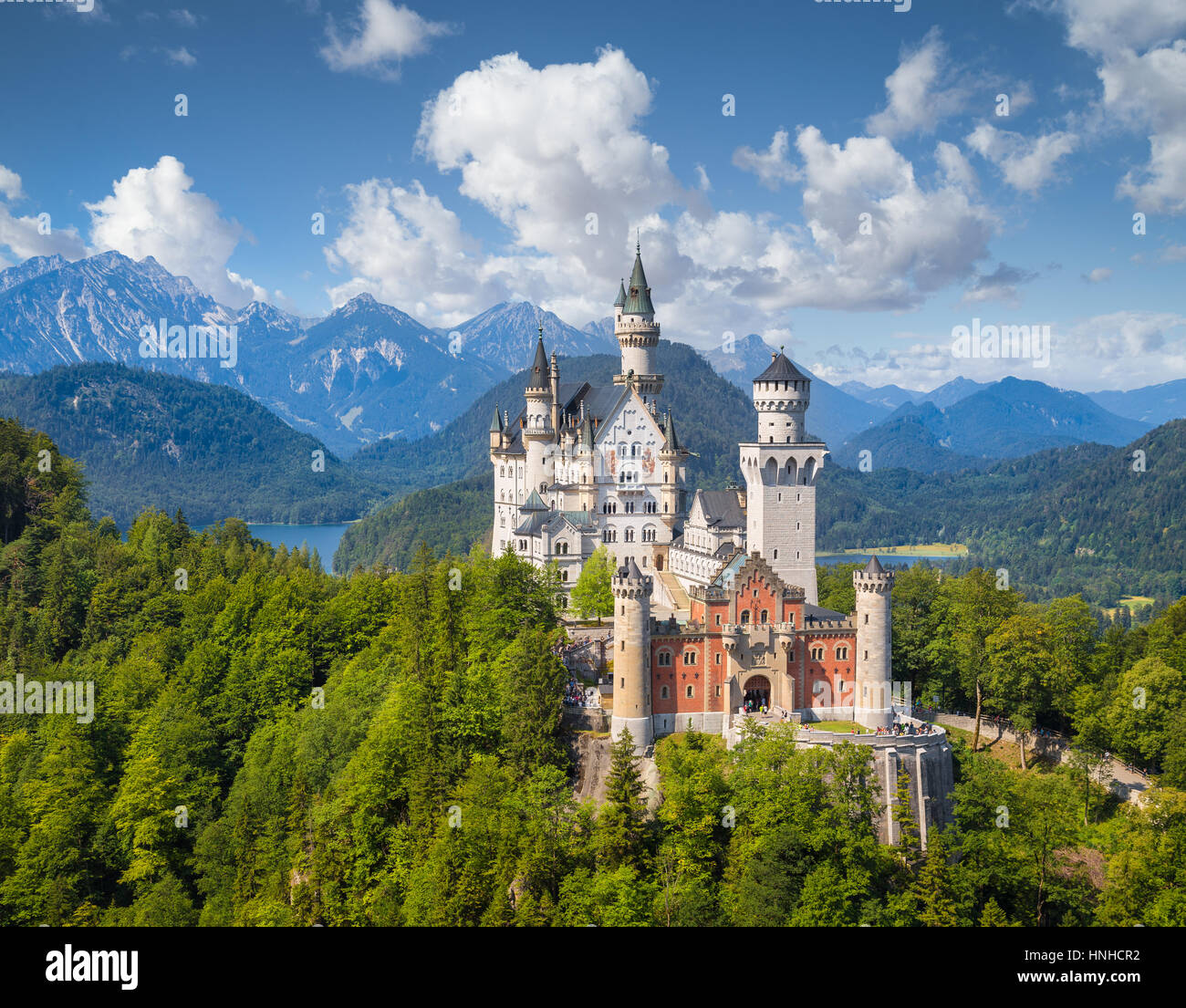 Classic view of famous Neuschwanstein Castle on a beautiful sunny day with blue sky and clouds in summer, town of Fussen, Allgau, Bavaria, Germany Stock Photo