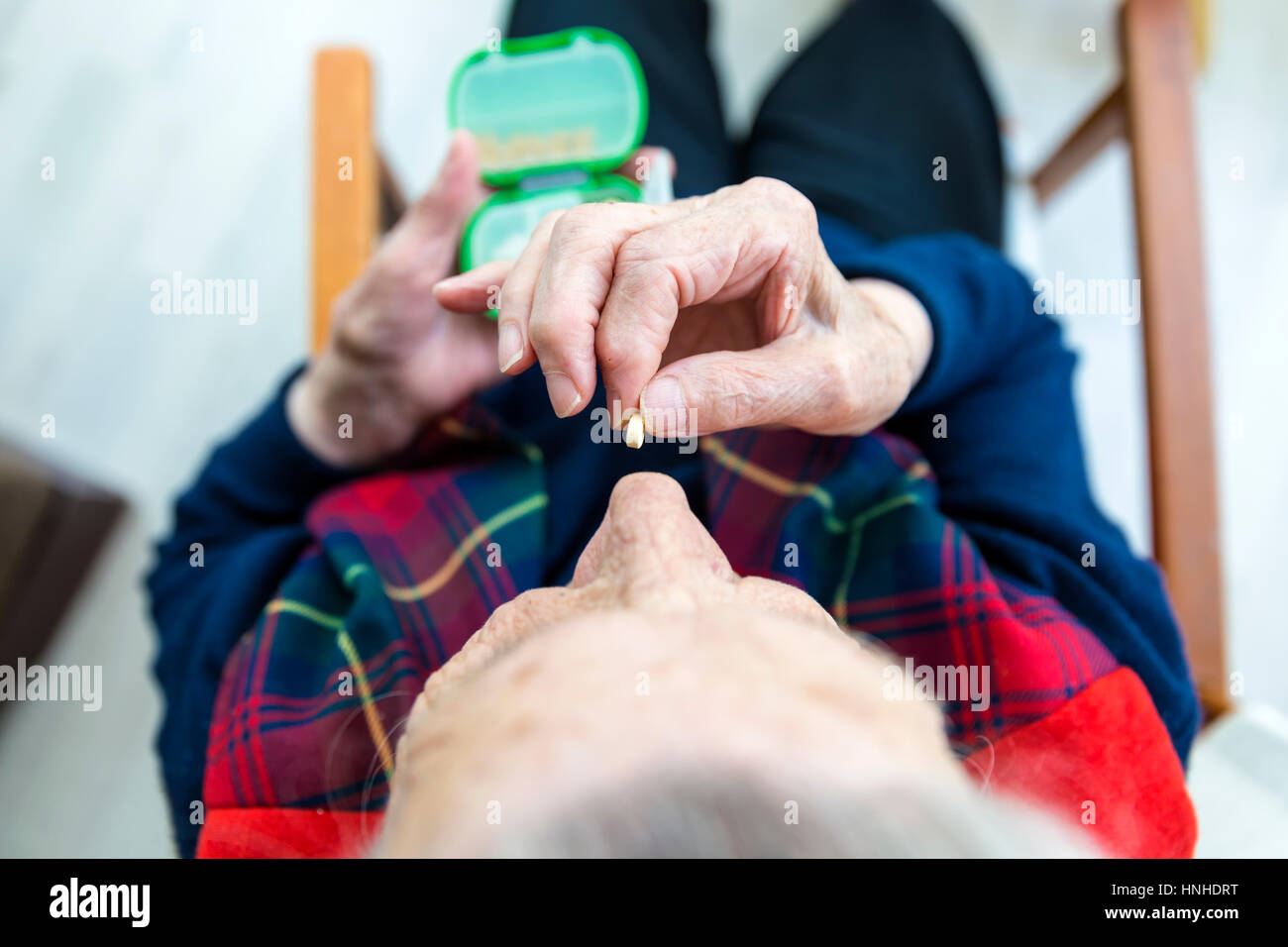 Elderly Turkish woman taking pills closeup view Stock Photo
