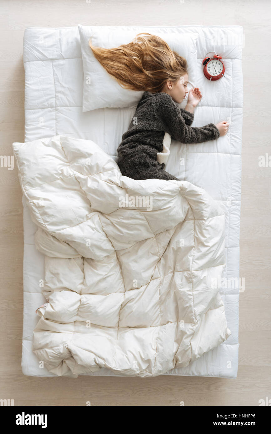 Charming pretty child sleeping next to clock Stock Photo Alamy