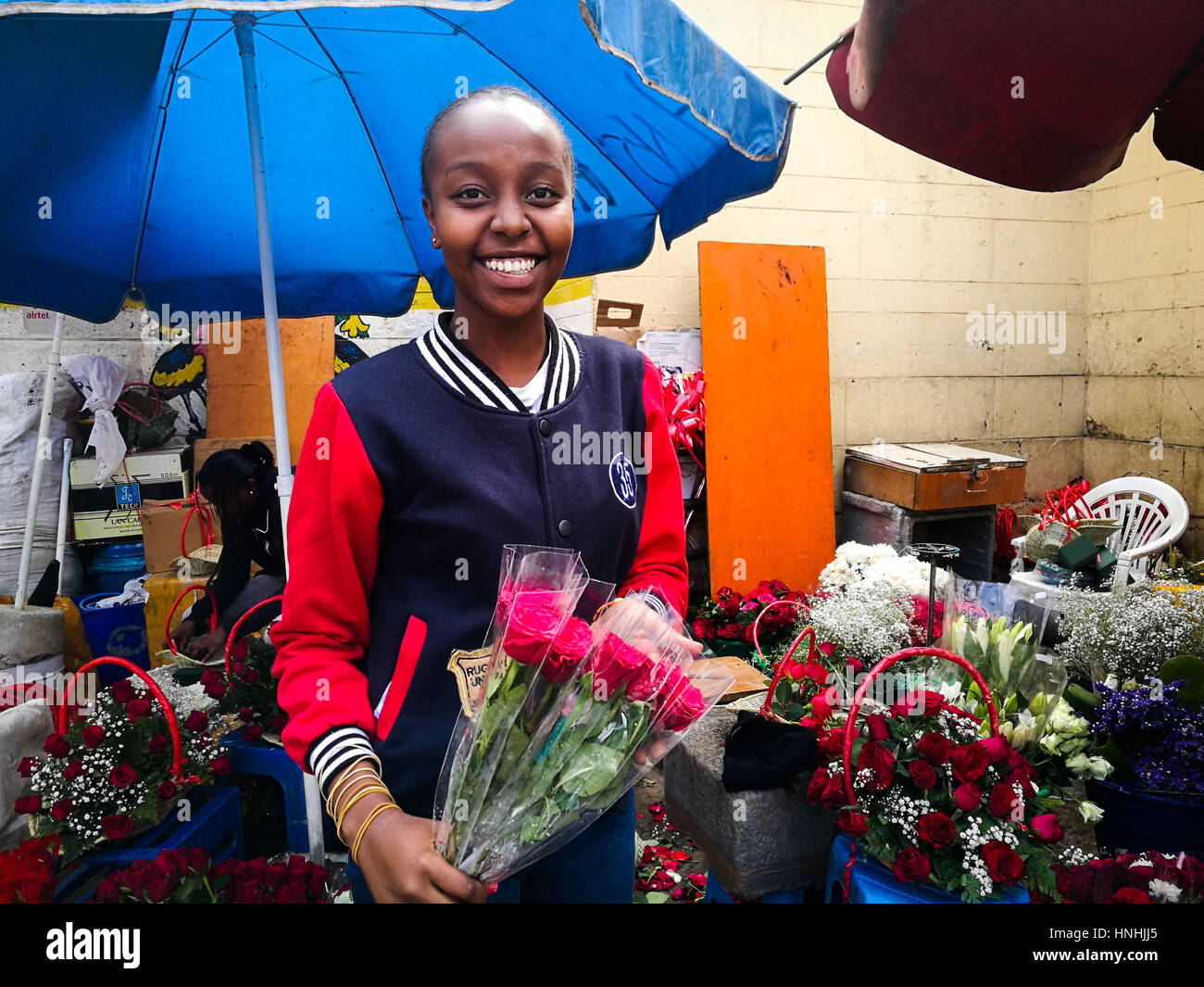 Nairobi, Kenya. 13th Feb, 2017. A girl shows flowers for sale at City Market in Nairobi, Kenya