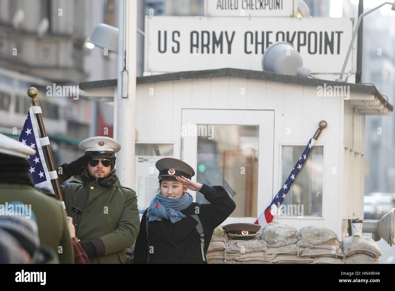 Berlin, Germany. 13th Feb, 2017. Tourists are seen having their picture taken on a cold morning on 13 February, 2017 at checkpoint Charlie where formerly the border between the Soviet occupied East and free Western part of the city existed. Credit: Willem Arriens/Alamy Live News Stock Photo