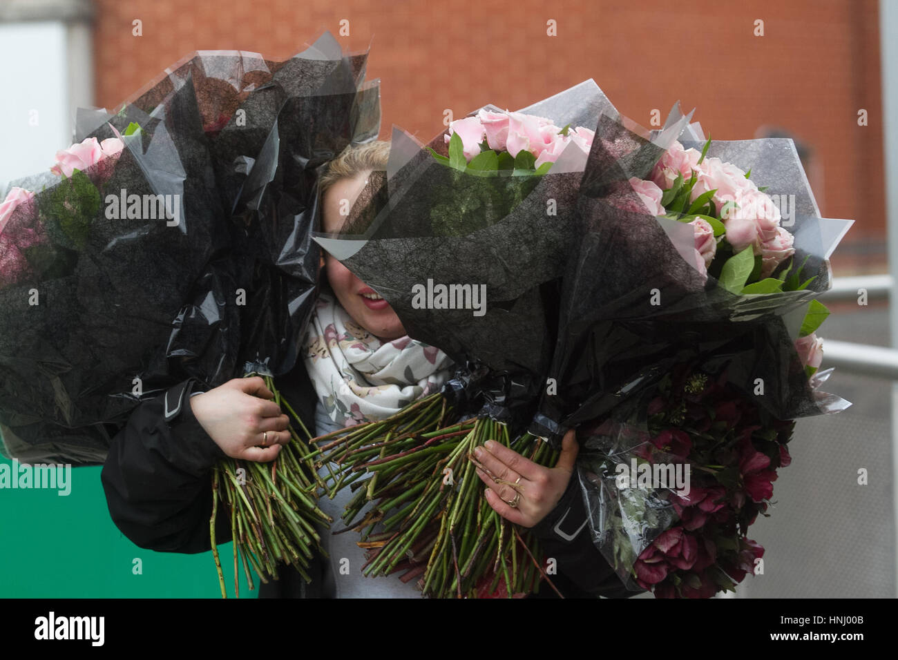 Wimbledon London UK. 14th February 2017. A florist carries large bouquets of flowers on Valentines Day, which is celebrated as most romantic day of the calendar when many people show affection by offering flowers to their loved ones Credit: amer ghazzal/Alamy Live News Stock Photo
