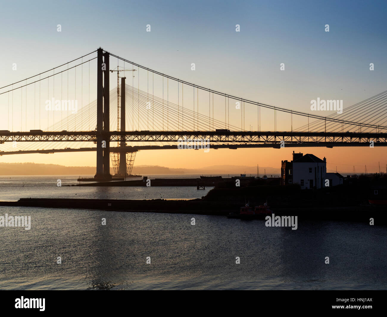 Forth Road Bridge at Sunset with the Queensferry Crossing Behind North Queensferry Fife Scotland Stock Photo