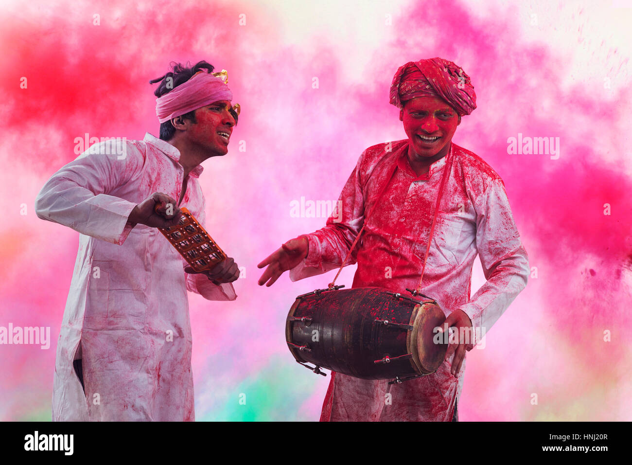 Two Young Indian men With Colored Face Dancing During Holi Color festival Stock Photo