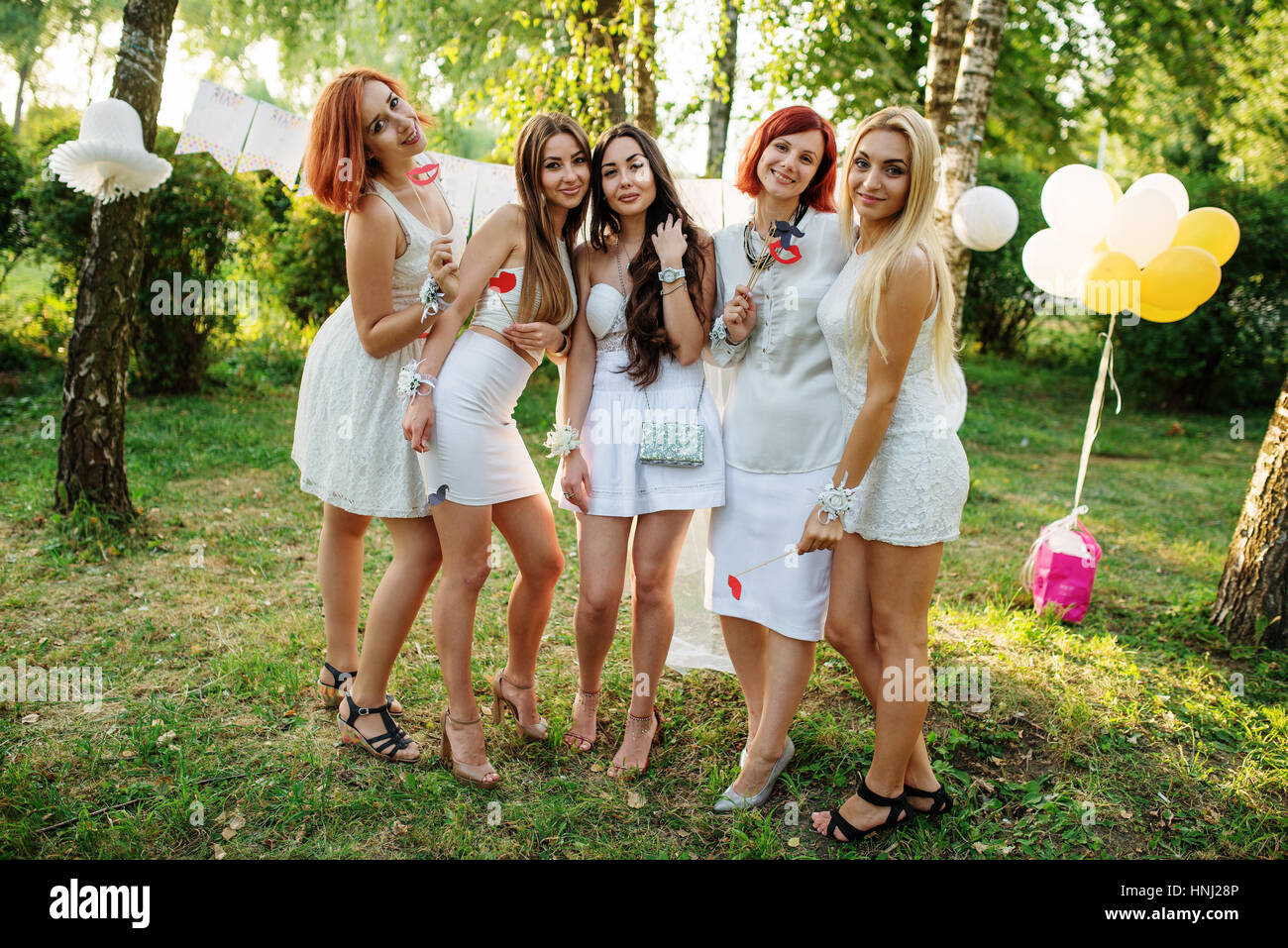 Girls wearing on white dresses having fun on hen party Stock Photo Alamy