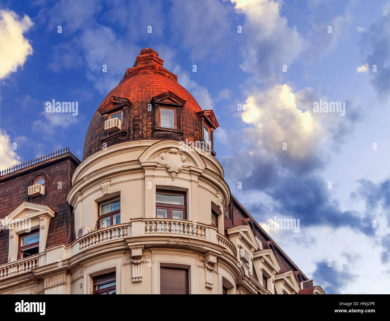 Historic building with dramatic blue cloudy sky Stock Photo - Alamy