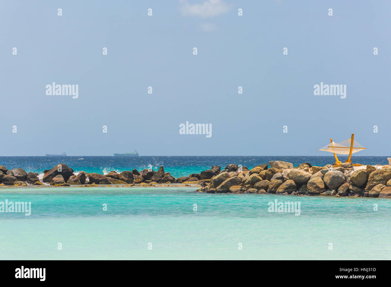 Empty hammock on tropical beach in flamingo island. Aruba Stock Photo