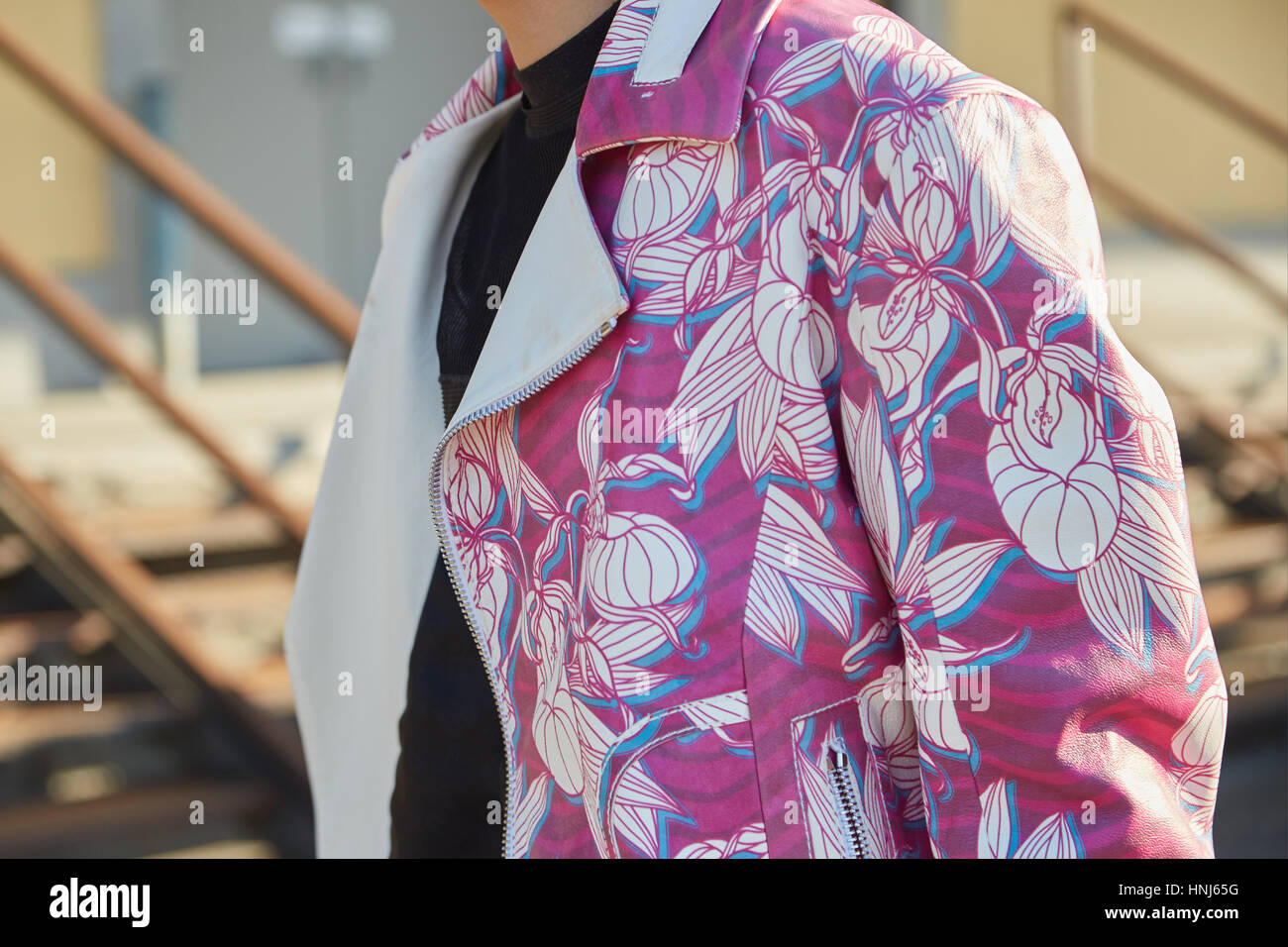 MILAN - JANUARY 15: Woman with pink and white floral design jacket 