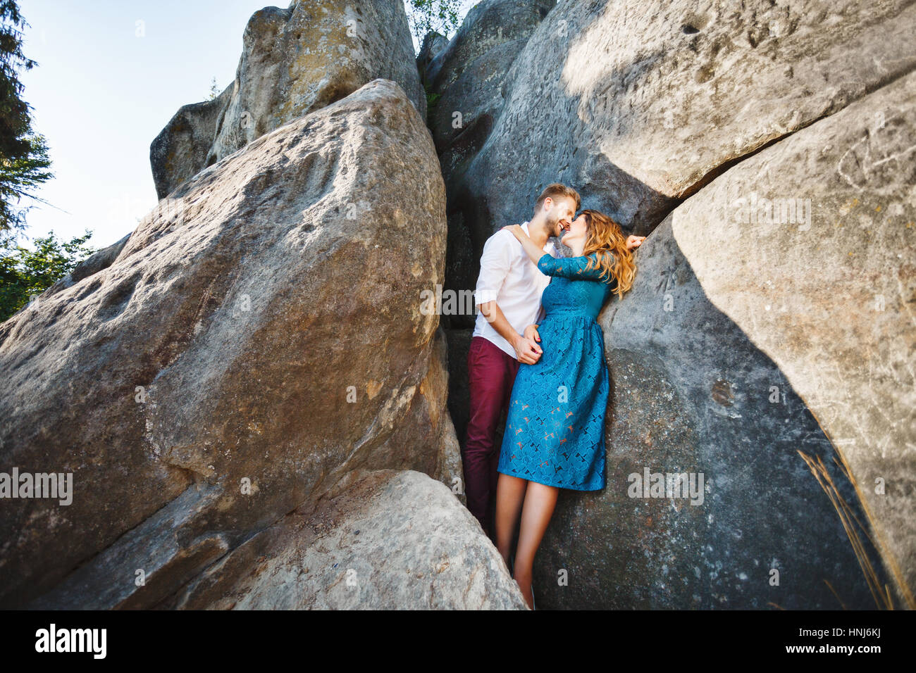Cute couple embracing near rocks Stock Photo - Alamy