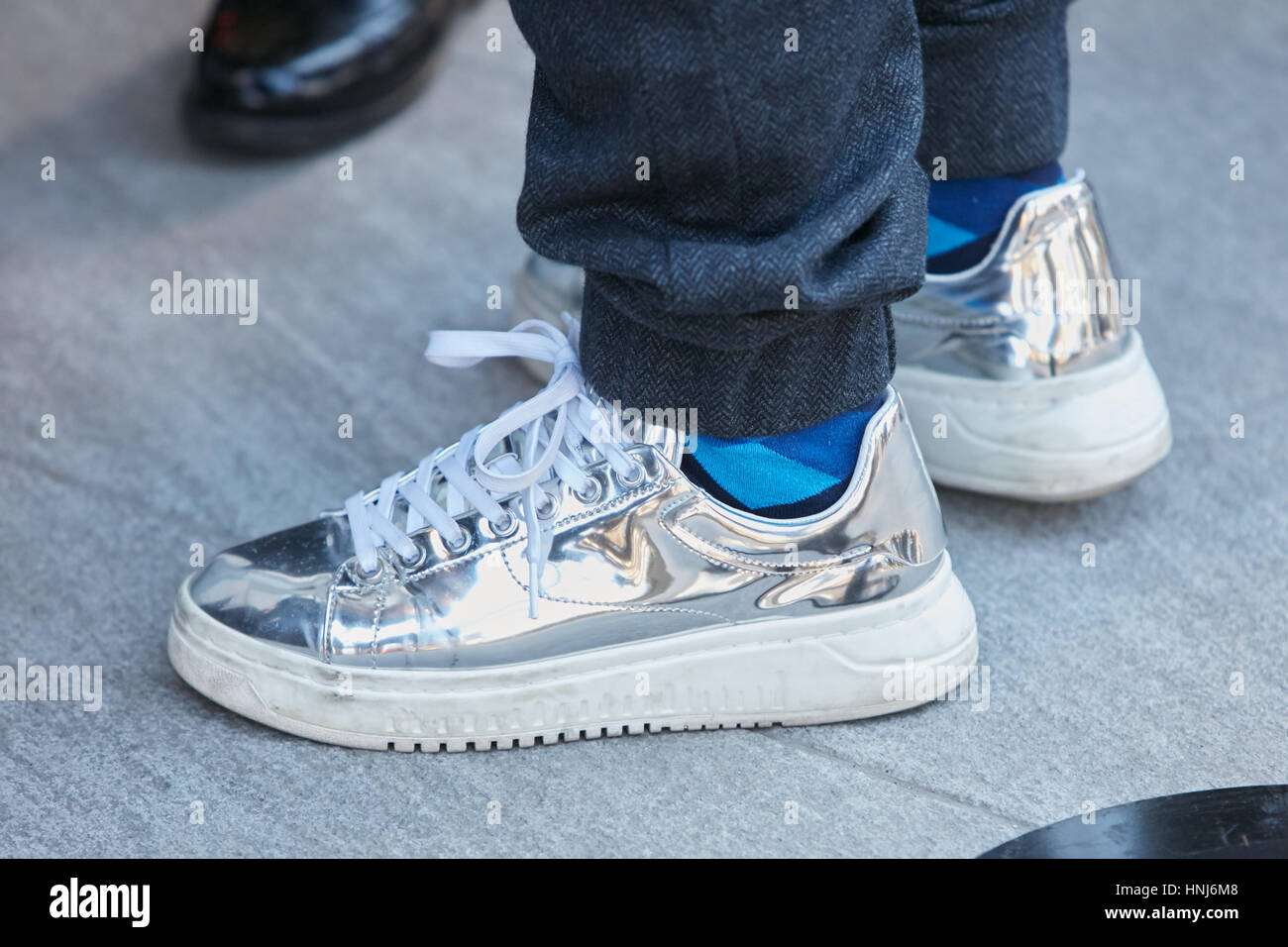 Man with silver sport shoes before Emporio Armani fashion show, Milan Fashion Week street style on January 14, 2017 in Milan Stock Photo