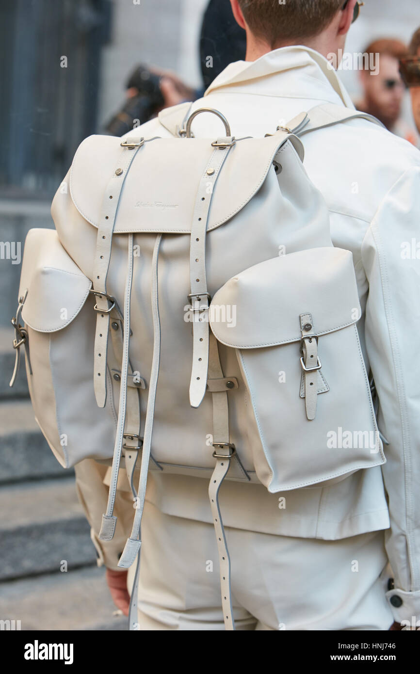 Man with white Salvatore Ferragamo leather backpack before Salvatore Ferragamo fashion show, Milan Fashion Week street style on January 2017. Stock Photo