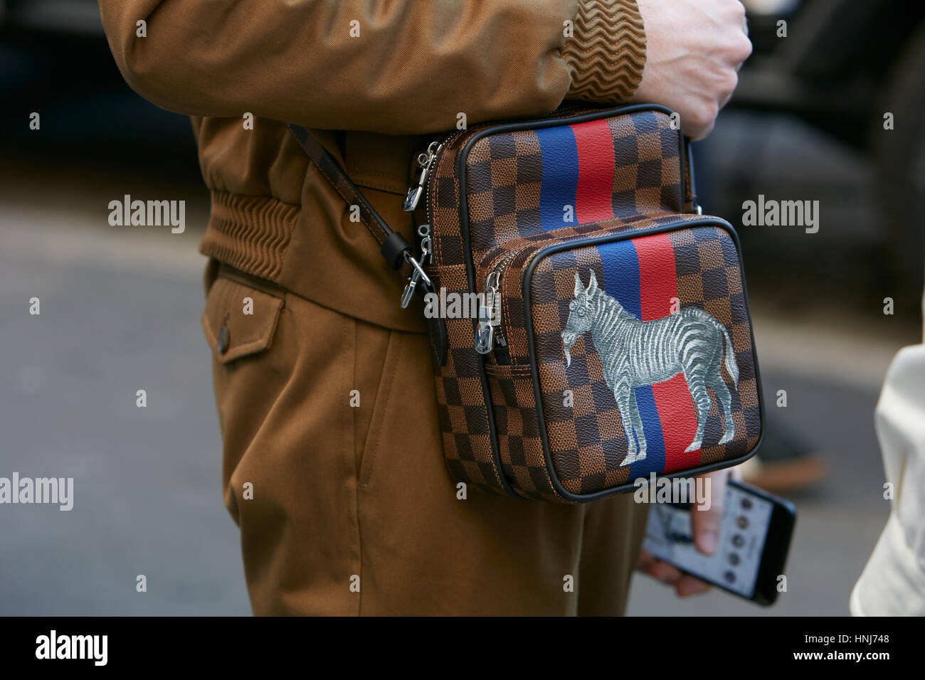 Man with Louis Vuitton small bag with zebra design before