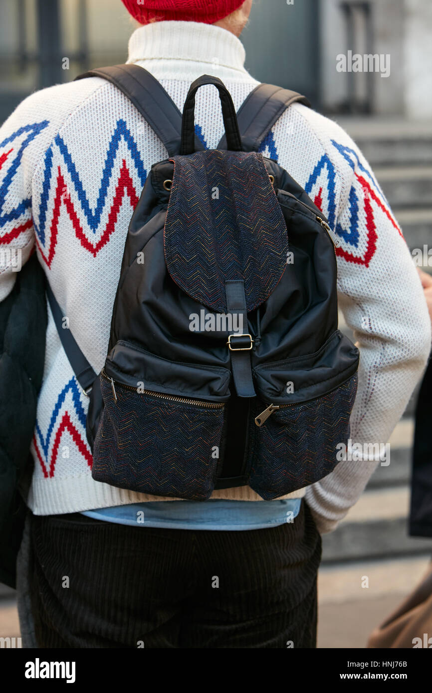 Man with white sweater with blue and red design before Salvatore Ferragamo fashion show, Milan Fashion Week street style on January 2017. Stock Photo