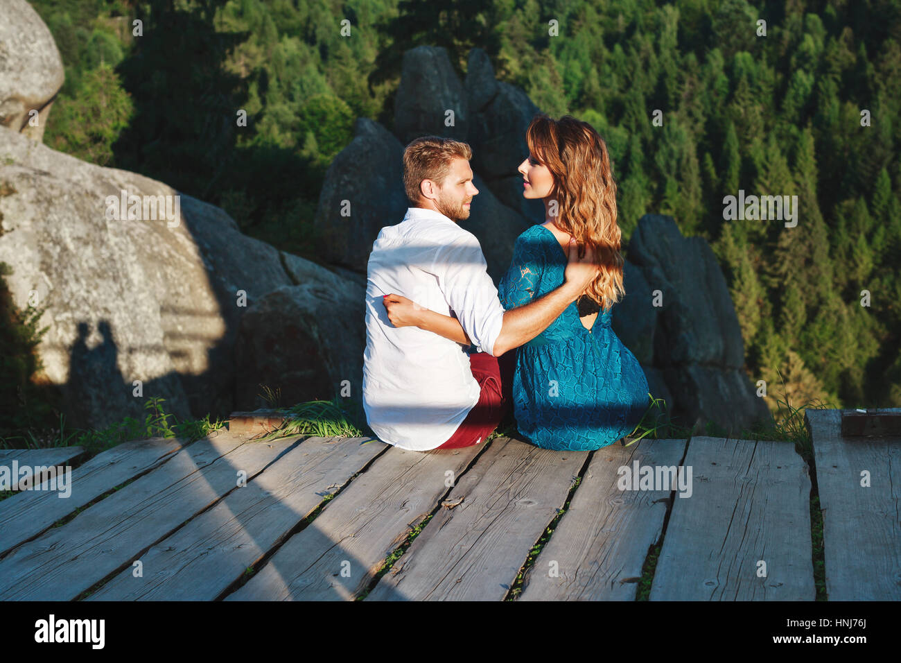 Loving couple embracing sitting hi-res stock photography and images - Alamy