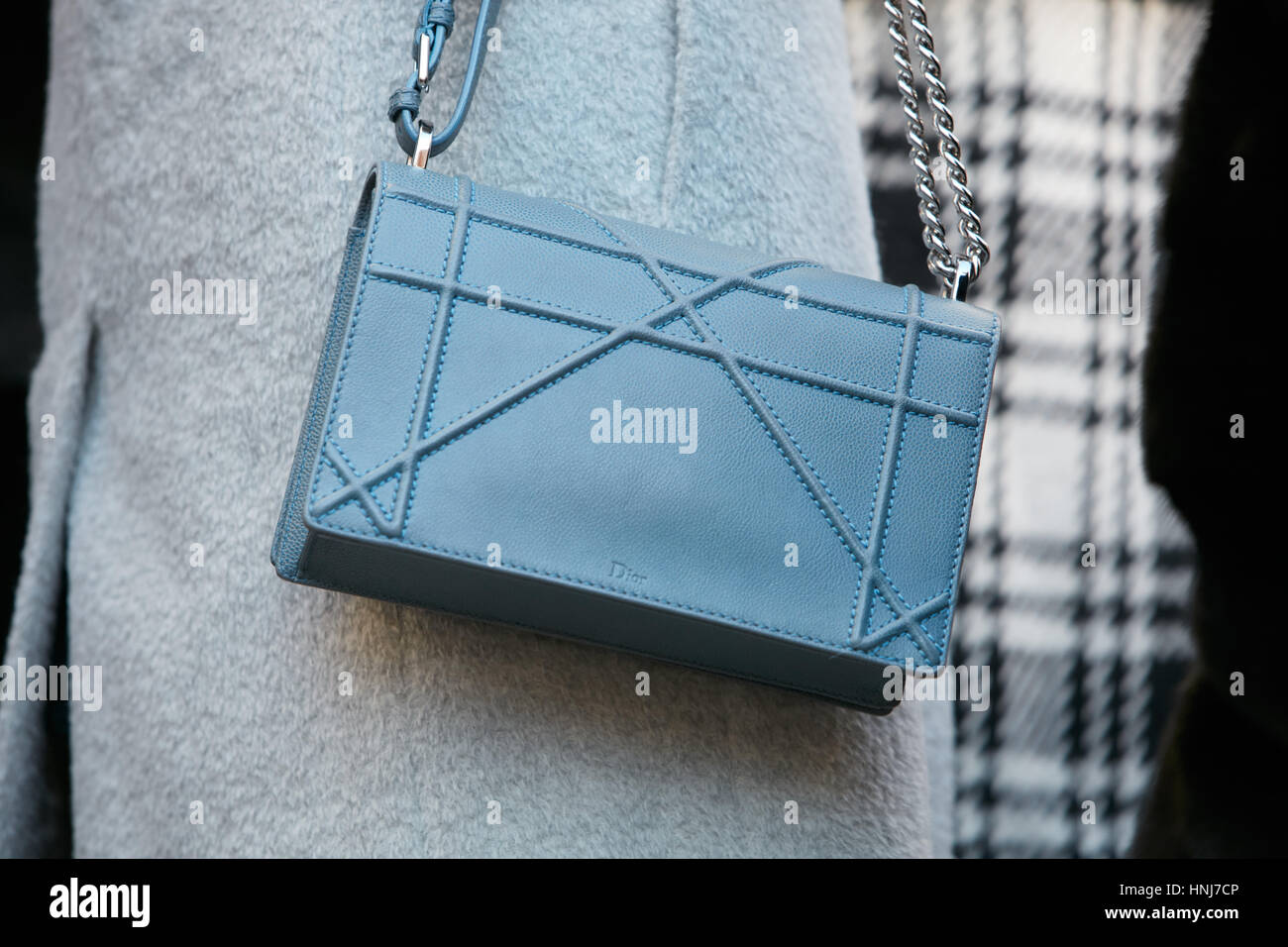Woman with blue leather Dior bag before Salvatore Ferragamo fashion show, Milan Fashion Week street style on January 15, 2017 in Milan. Stock Photo