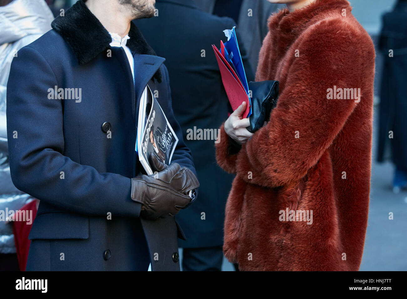 Men with brown fur and blue jacket talking before MSGM fashion show, Milan Fashion Week street style on January 16, 2017 in Milan. Stock Photo