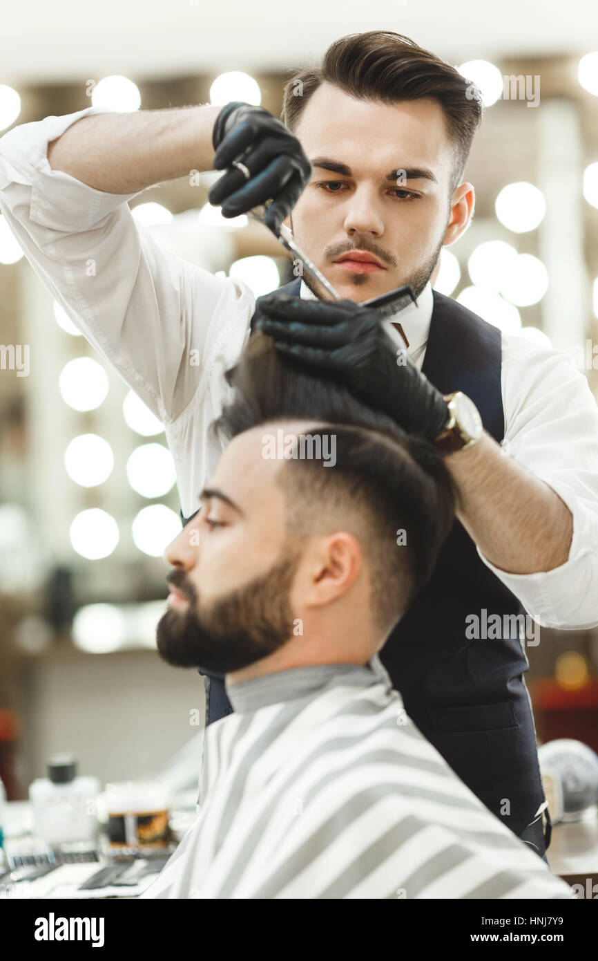 Barber doing haircuts for client Stock Photo