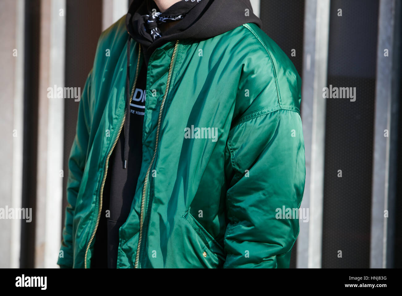 Man with green bomber jacket before Giorgio Armani fashion show, Milan Fashion Week street style on January 17, 2017 in Milan. Stock Photo