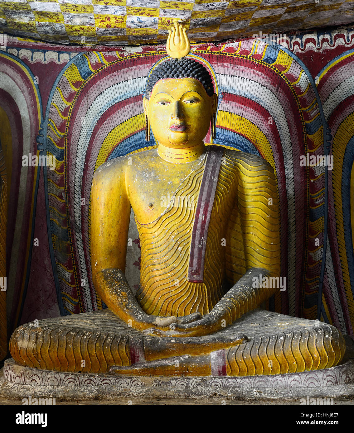 Insides of caves in ancient Buddhist complex in Dambulla cave temple. Sri Lanka. The photograph is presenting the statue of sitting Buddha Stock Photo
