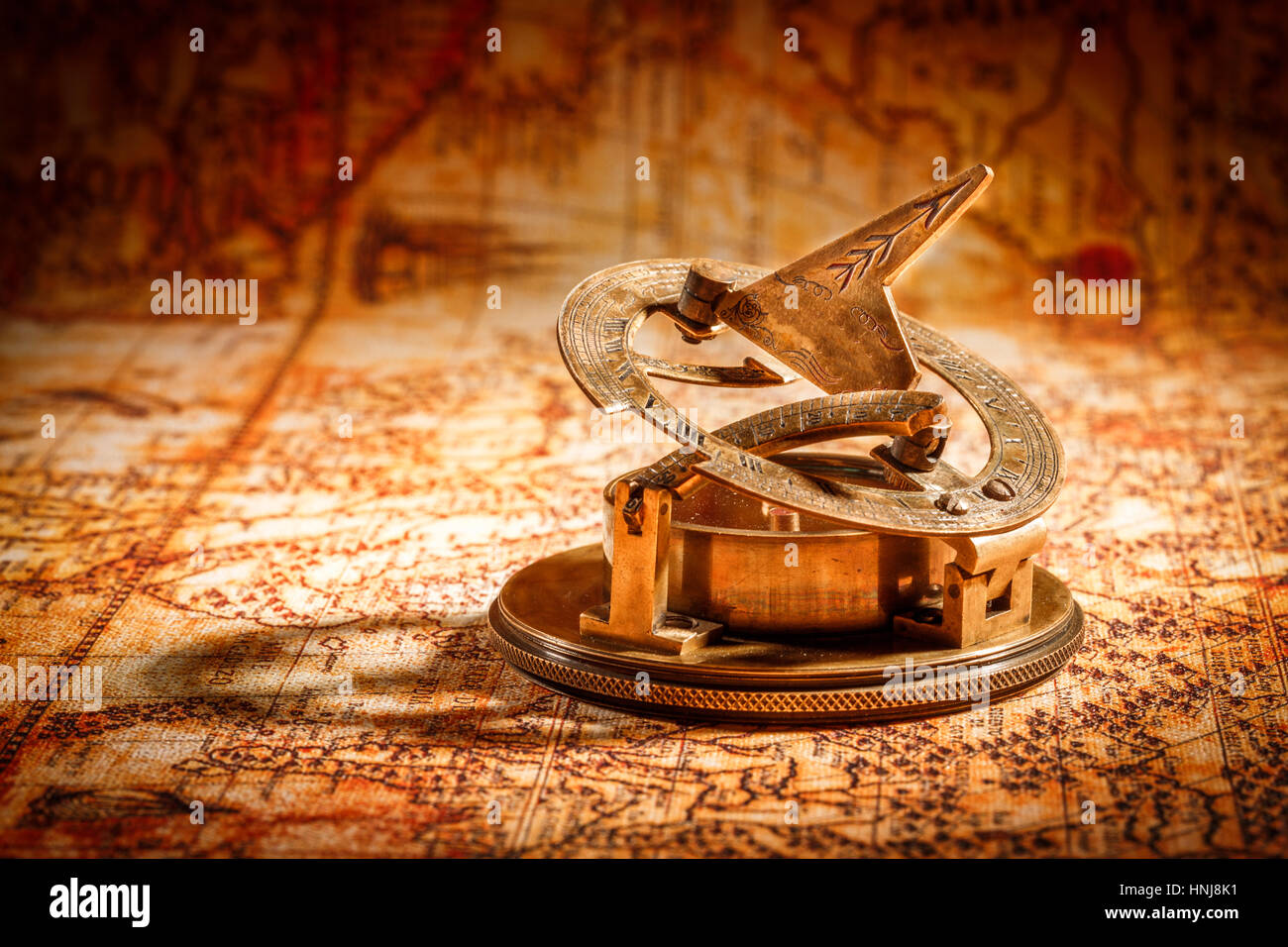 Vintage still life. Vintage compass lies on an ancient world map in 1565. Stock Photo