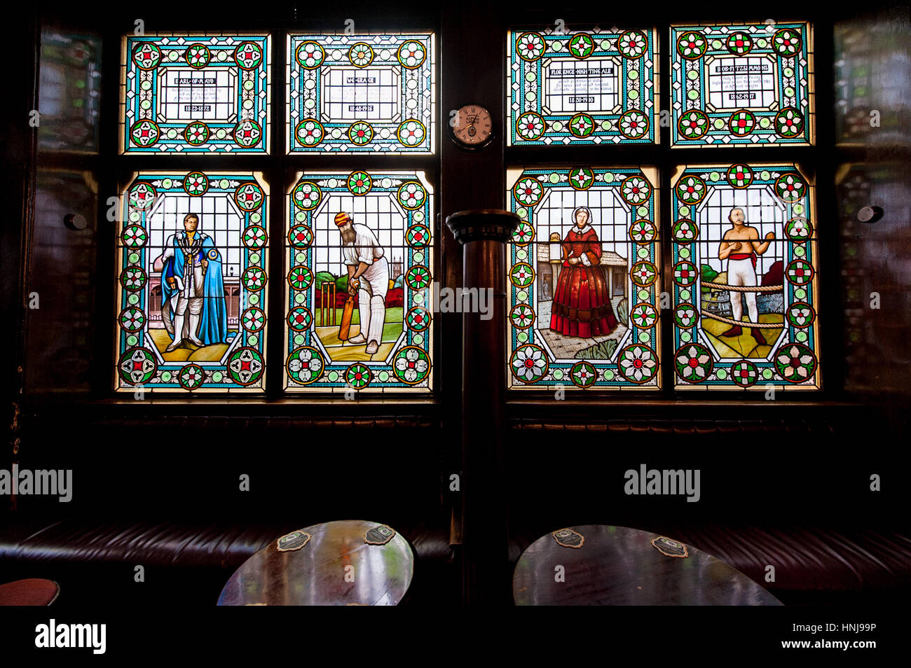 An interior of an old London pub with amazing stained glass windows. Stock Photo