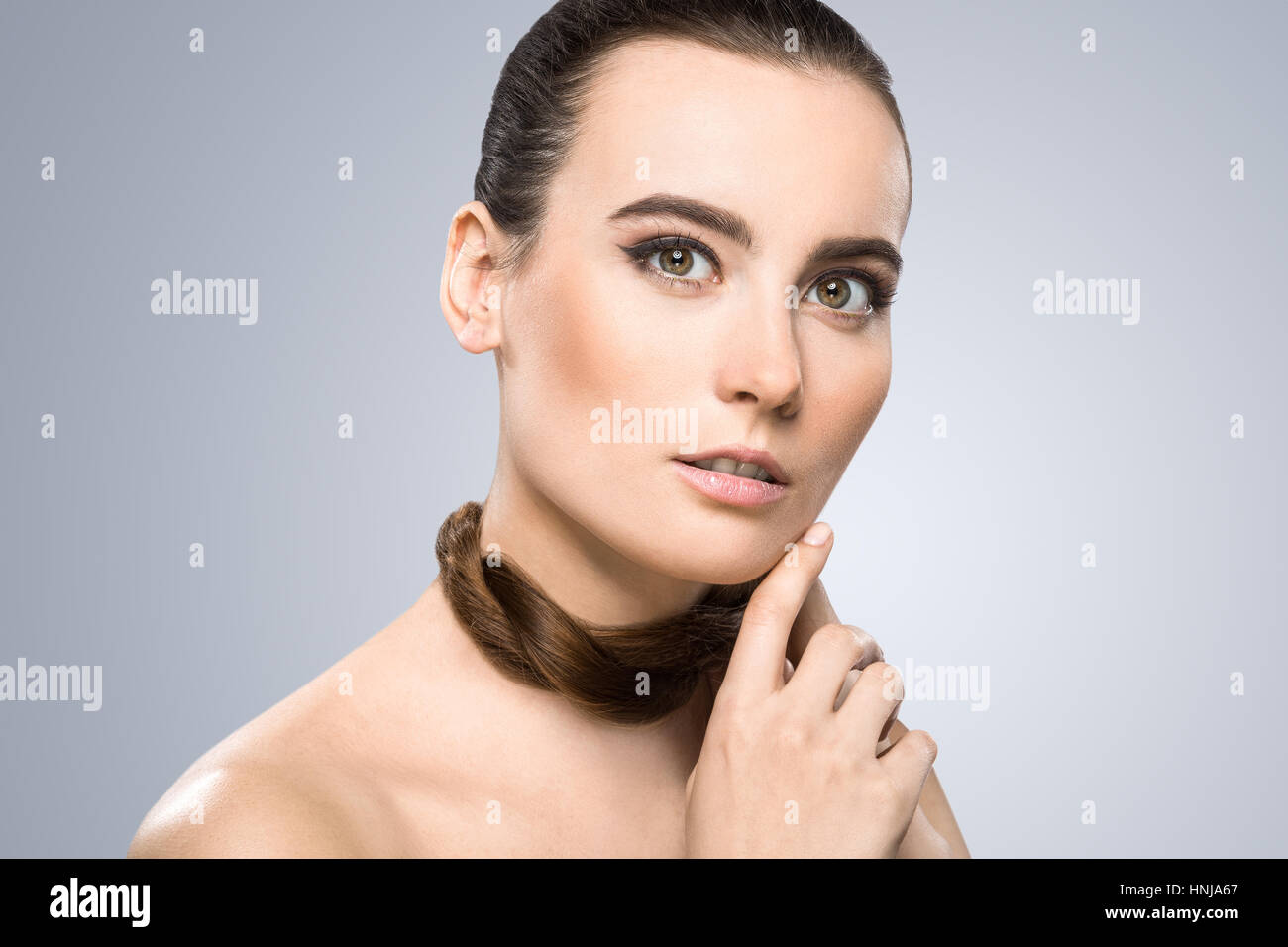 Model holding pigtail around her neck Stock Photo Alamy