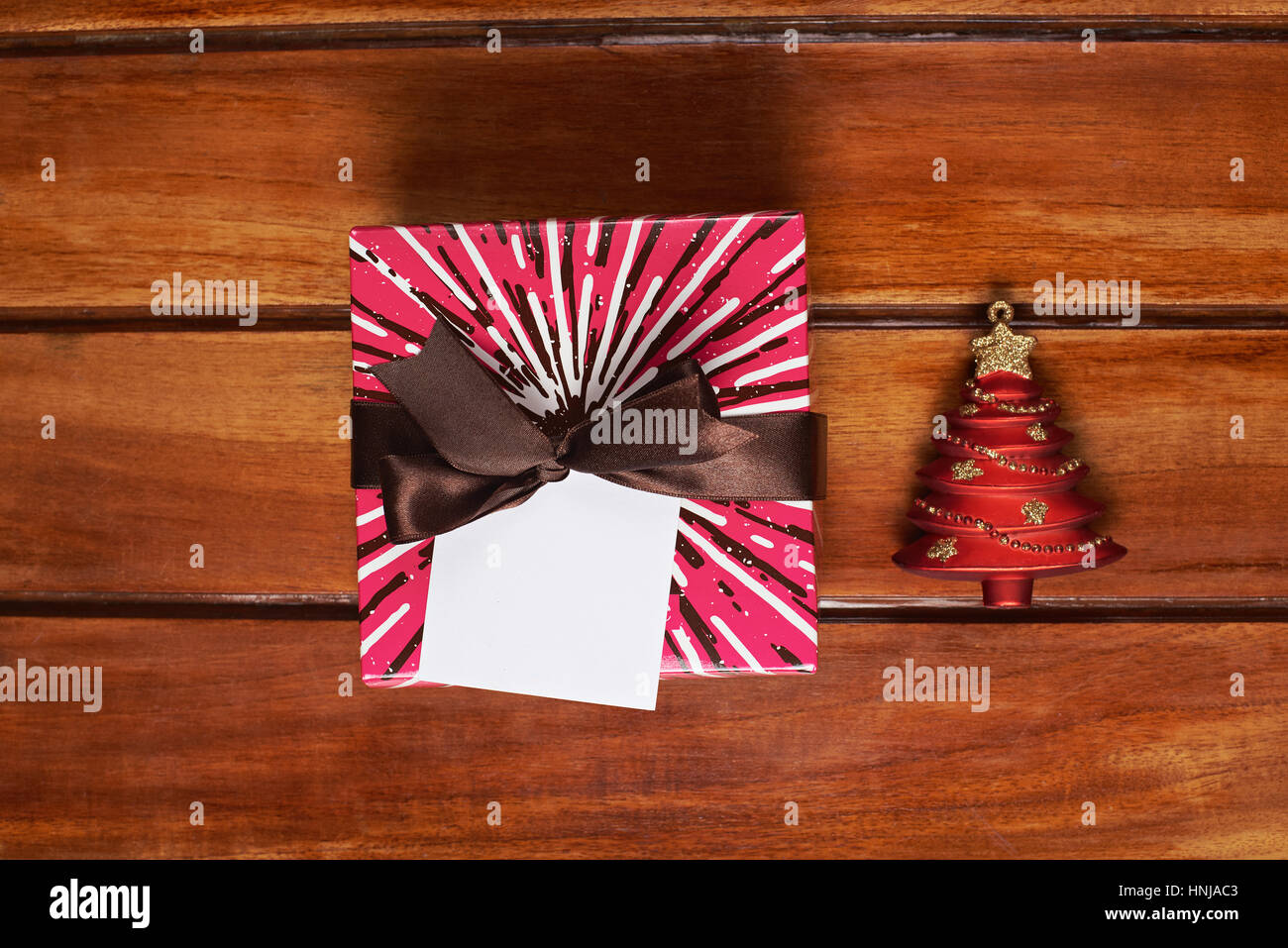 close up of christmas gift box on wooden brown table Stock Photo