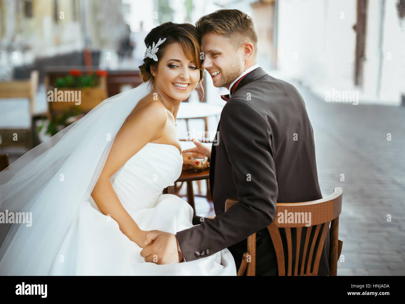Bride and groom sitting on chairs Stock Photo - Alamy
