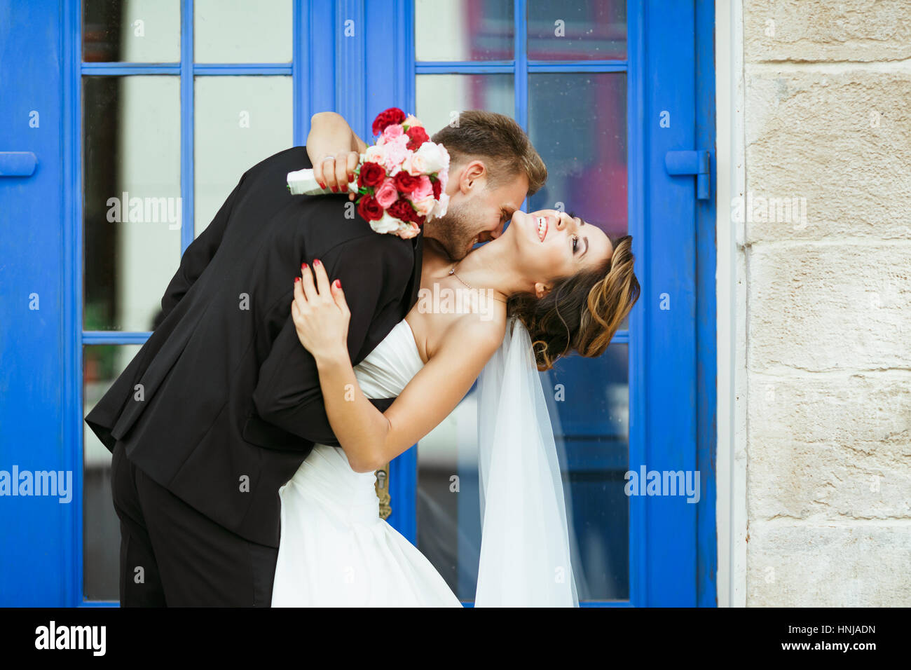 Loving groom bride embracing kissing hi-res stock photography and ...