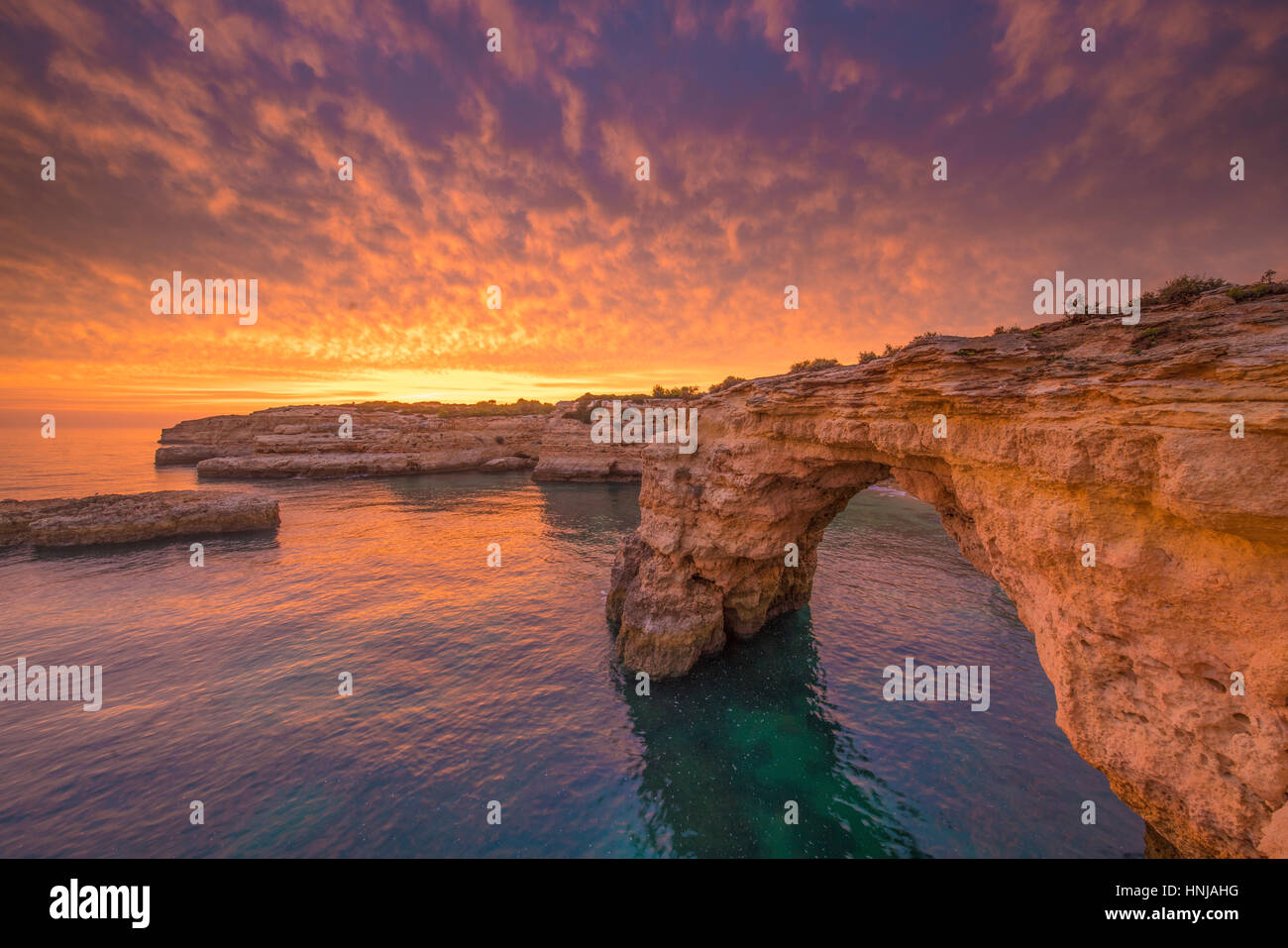 Sea arch at sunrise on Algrave Coast, Portugal, Atlantic Ocean   Near Lagoa Stock Photo