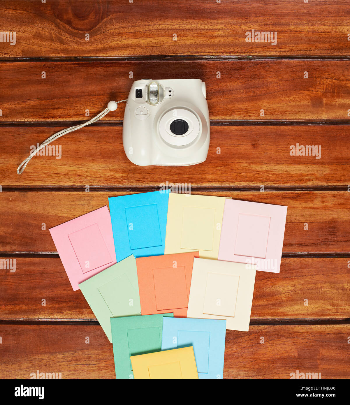 Instant camera colorful frames on wood desk table Stock Photo