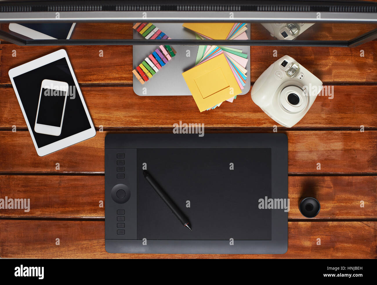 All need gadgets for graphic designer on wooden table computer screen,tablet, instant camera and smarphone Stock Photo