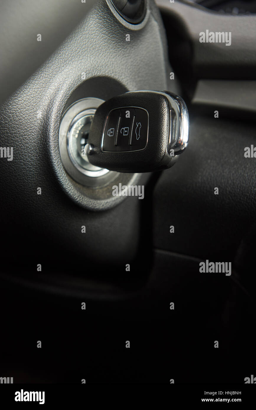 Close up of car key in keyhole for ignition. Macro of modern start car