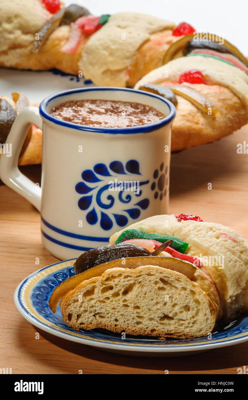 Chocolate cup with Epiphany cake, Kings cake, Roscon de reyes or Rosca de reyes Stock Photo
