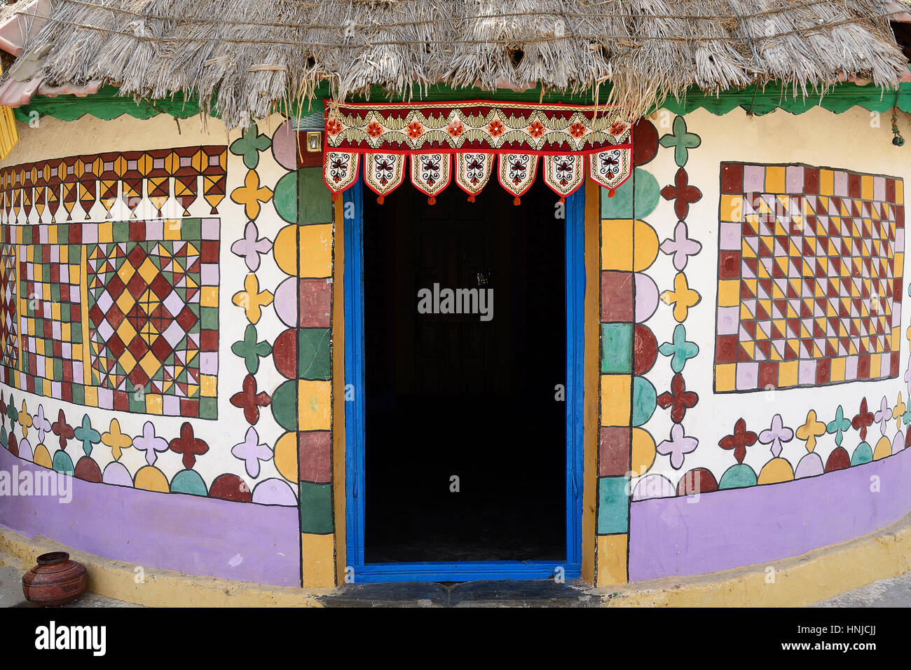 Traditionally decorated hut in the tribal village on the desert in India in the Gujarat state Stock Photo