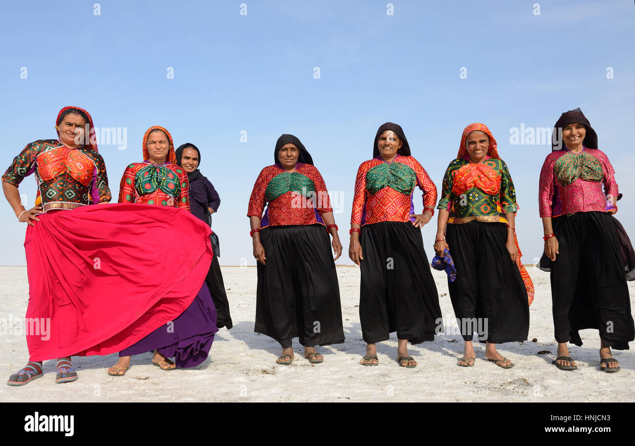 BHUJ, RAN OF KUCH, INDIA - JANUARY 13: The tribal woman in the traditional dress with the trip on the salt desert in of Ran of Kuch in the Gujarat sta Stock Photo