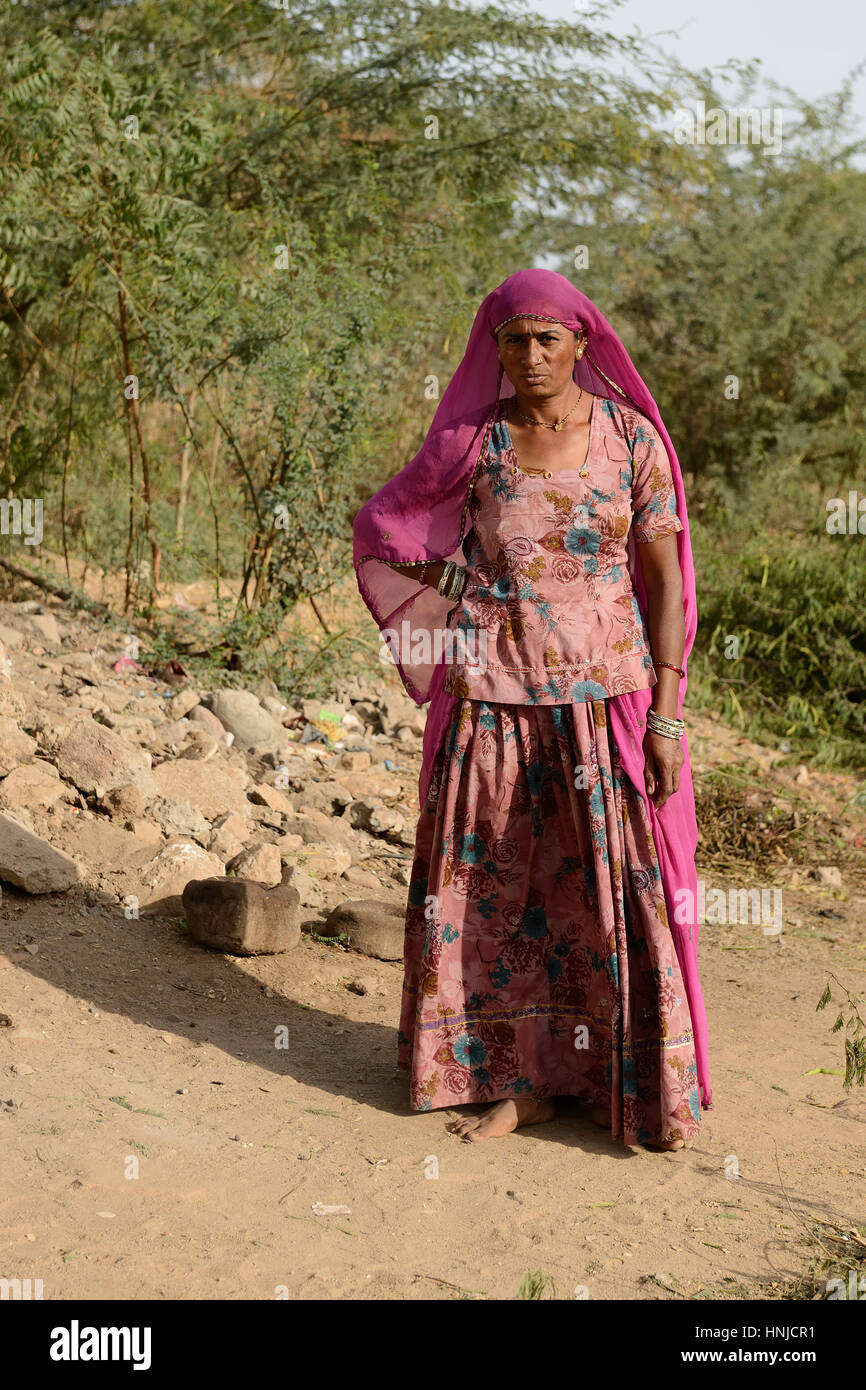 BHUJ, RAN OF KUCH, INDIA - JANUARY 13: The tribal woman in the traditional dress he is going through deserts in of Ran of Kuch in the Gujarat state in Stock Photo