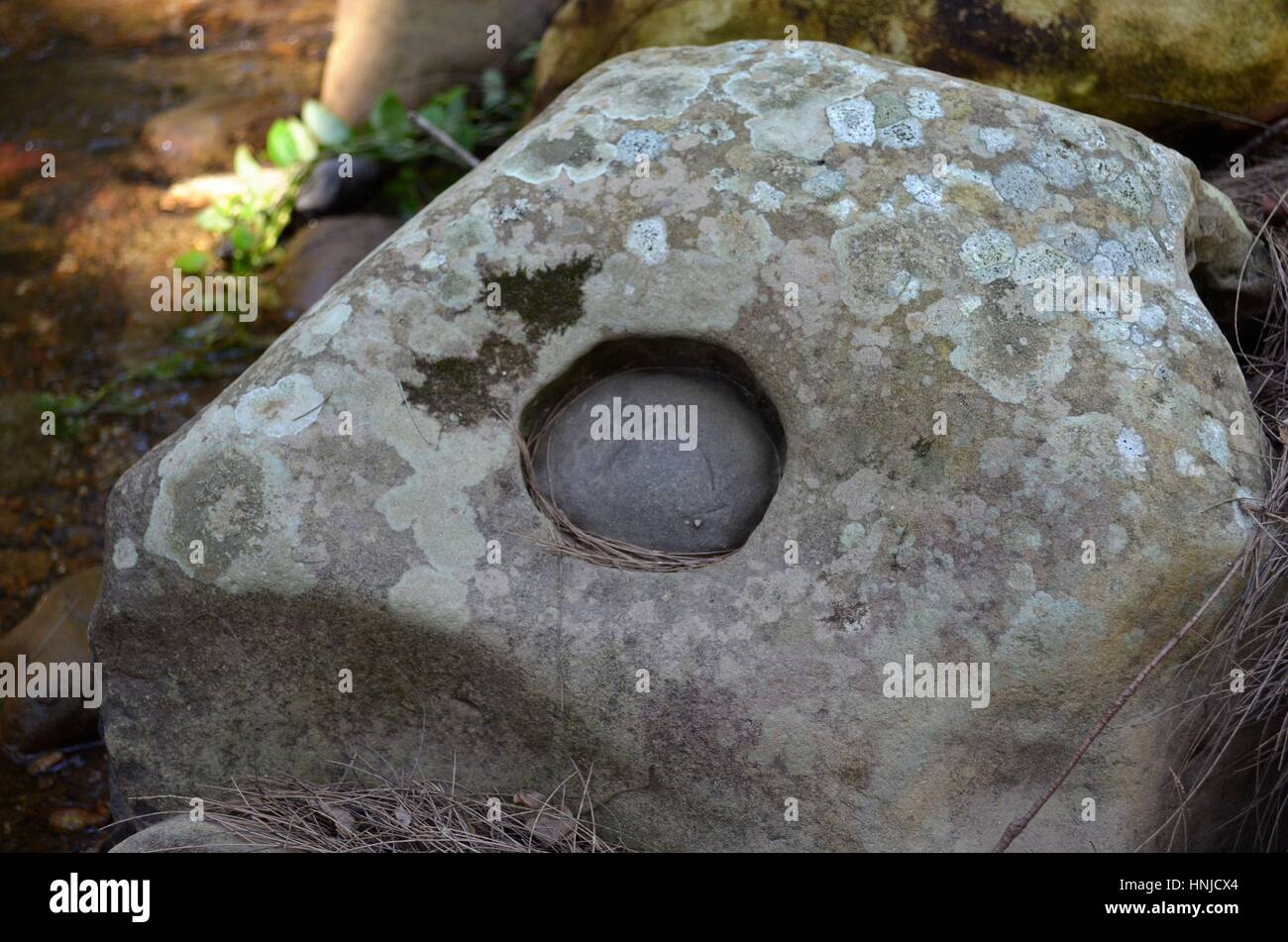 Gorgeous rock with natural circular hole Stock Photo